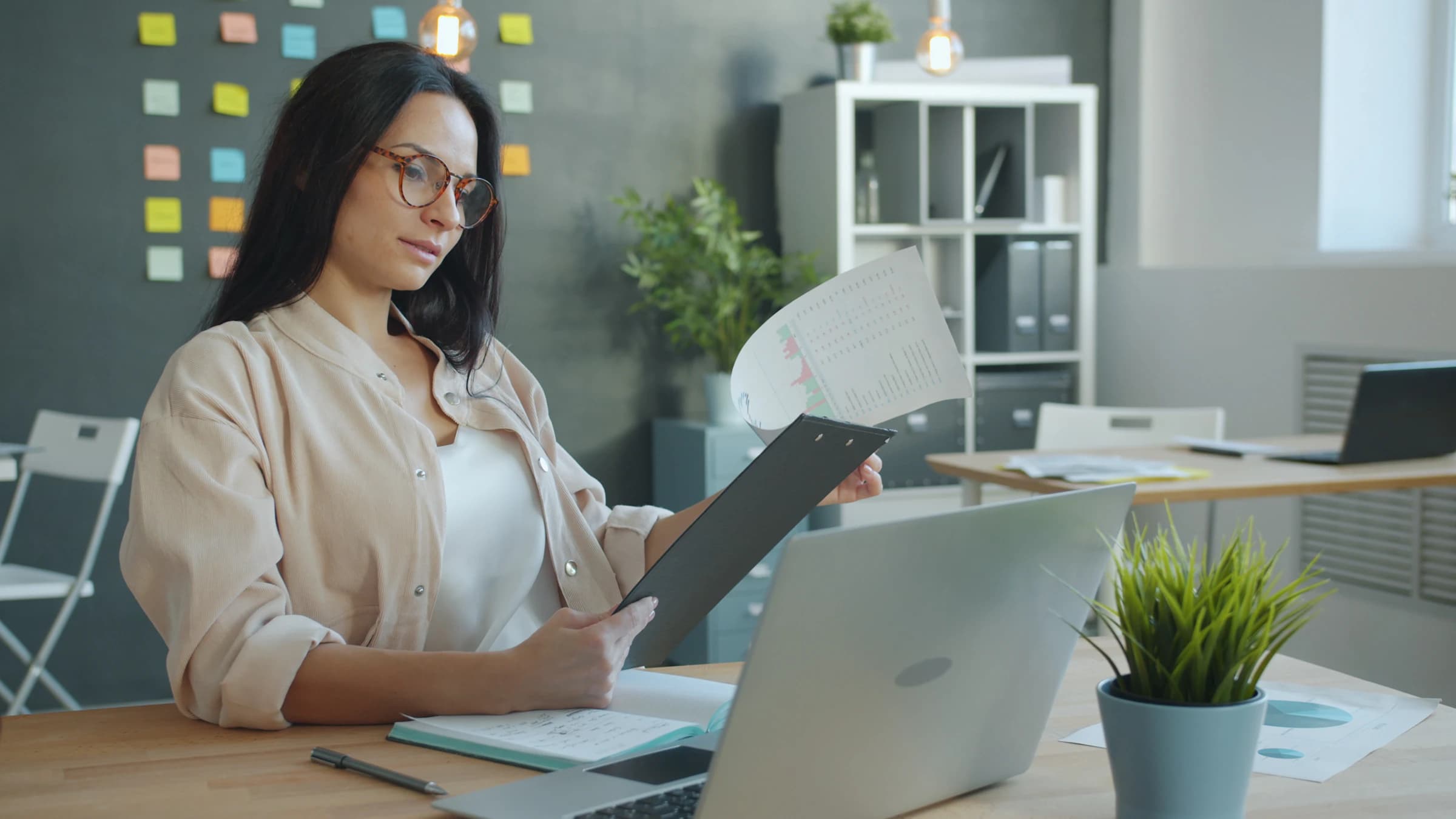 A professional reviewing organised documents at a desk
