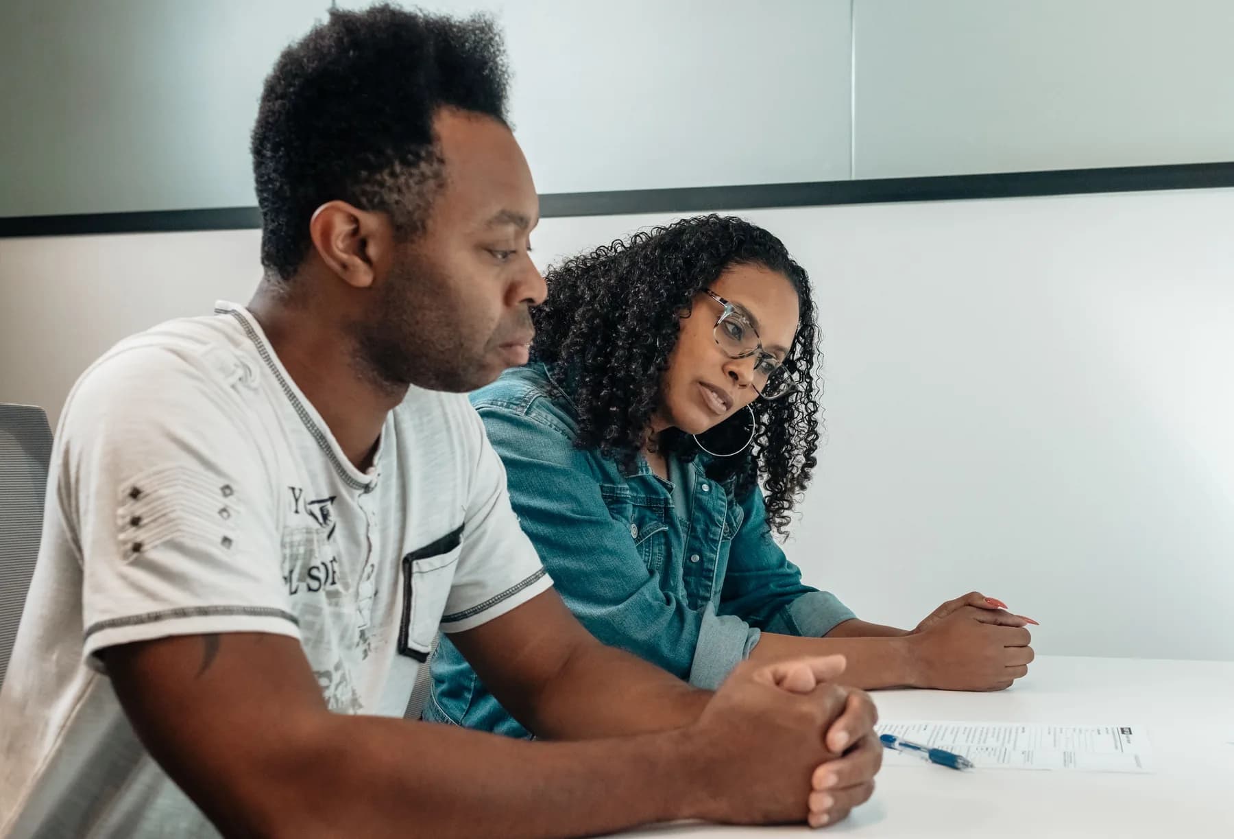Two clients reviewing an important document during a consultation