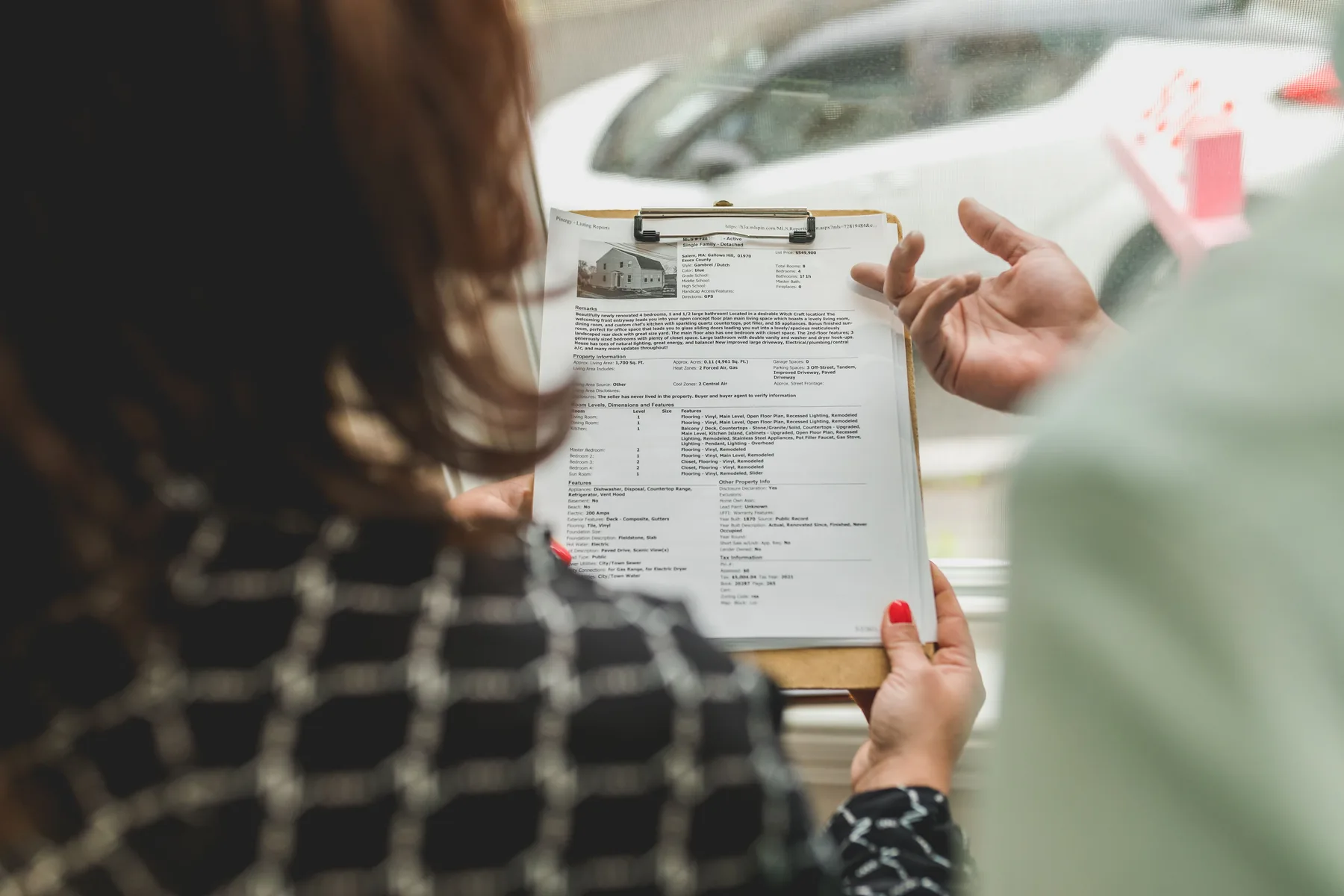 A property professional reviewing listing documents with a client