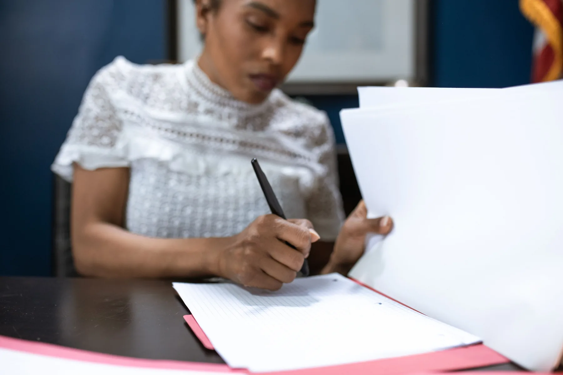 A professional signing and organising official documents